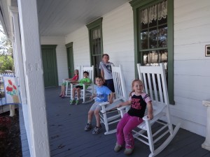Sitting on the cute front porch of the historical building.